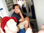 Sitting on Our Backpacks in front of the WC on the Train after 2½ Hours of Sleep