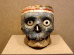 Skulls just aren't scary enough unless you plaster 'em with tiny rocks and stick big fake freaky eyes into the eye sockets.  Yeek.
