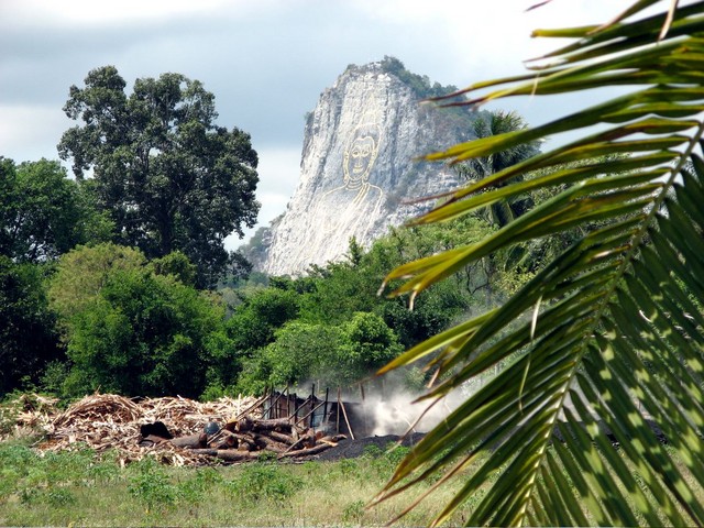 Giant golden buddha on the side of a mountain.  Nutso.