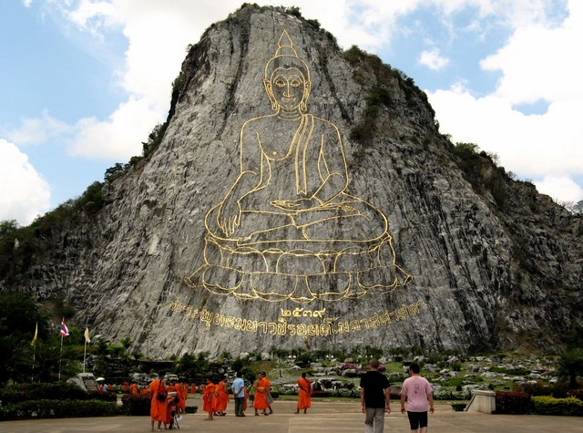 Lots of tiny monklets dwarfed by Giant Buddha